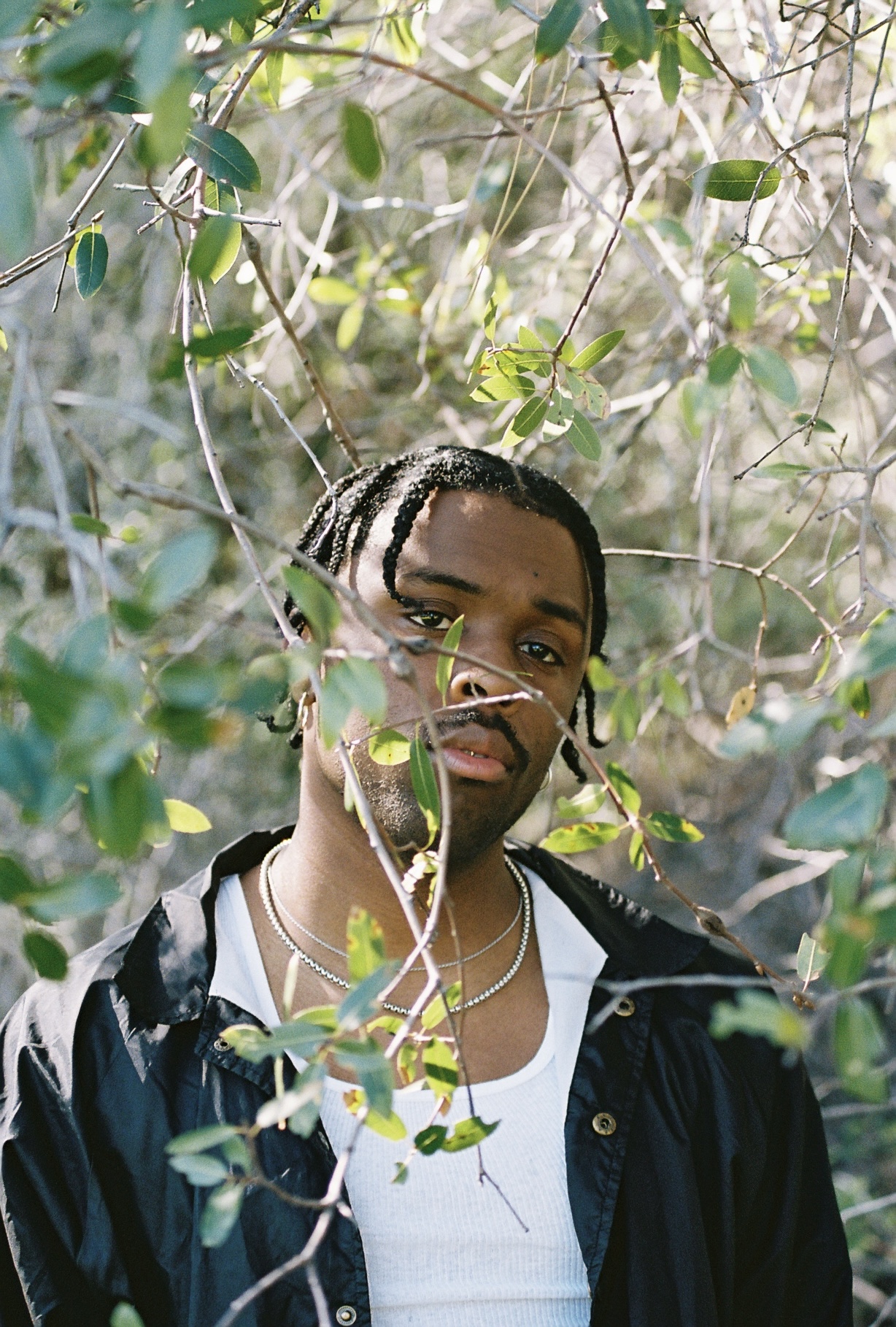 Film portrait through foliage
